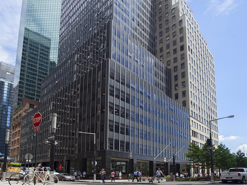 110 Wall Street seen from the street corner looking up, showing its many floors