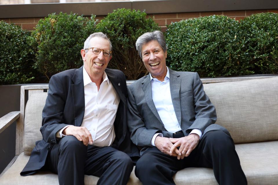 Bill and Eric Rudin sitting together outdoors
