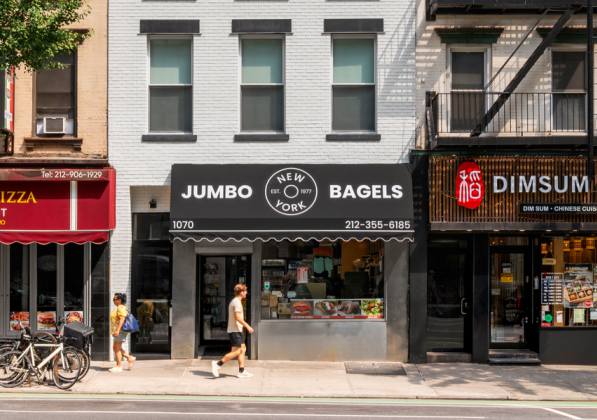 A street view of three retail spaces from a sidewalk with trees