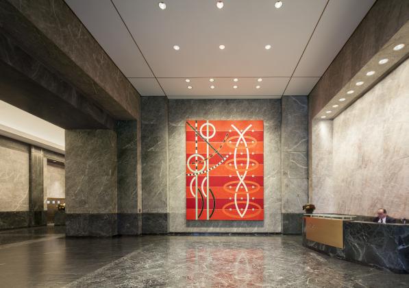 A sleek lobby with a large abstract painting displayed on the wall