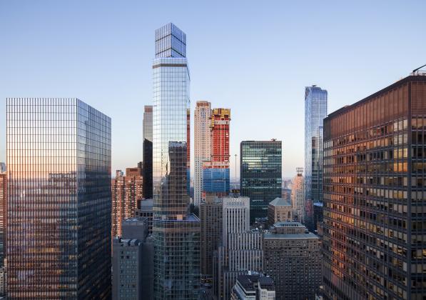 The tops of tall buildings with the sun reflecting off them