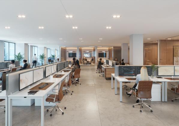 An open-concept office space with people working at desks and in meeting rooms