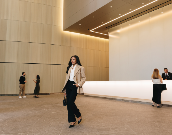 A business women walks through the lobby of an office building