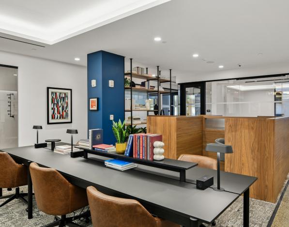 A meeting room with a rectagular table, chairs, and a podium for presentations behind it