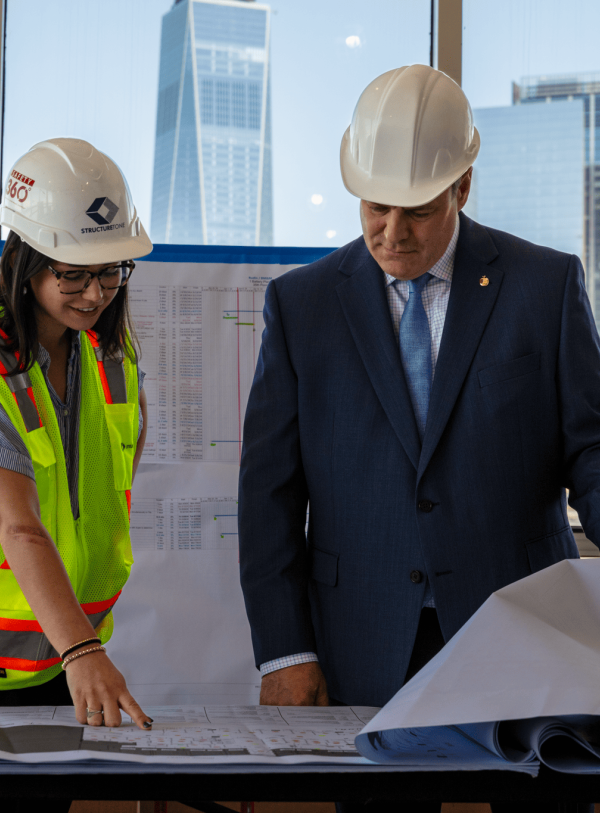 Two people looking at plans