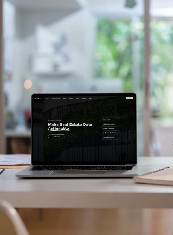 Open laptop with text "Make Real Estate Data Actionable"