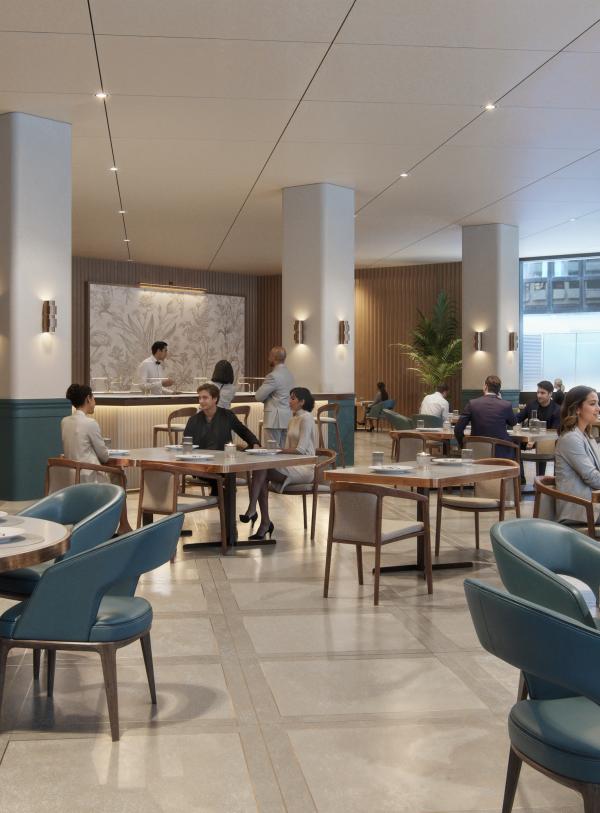 A restaurant with comfortable blue chairs placed around round tables