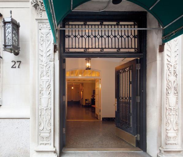 Looking through an open door to see the lobby of a building from a city street